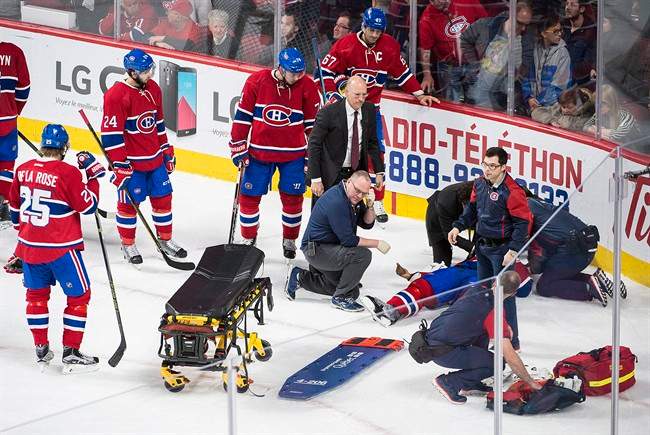 Montreal Canadiens players look on as teammate P.K. Subban lies injured on the ice during third period NHL hockey action against the Buffalo Sabres in Montreal, Thursday, March 10, 2016.