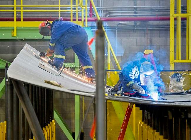 Workers construct components of the Arctic offshore patrol ships at the Irving shipbuilding facility in this file photo in Halifax on Friday, March 4, 2016. The chosen designs to replace the navy's warship fleet will be constructed by Irving.