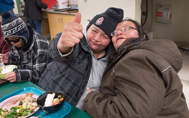 Bessie Strang hugs a homeless friend during dinner at the Shelter House, Friday, March 4, 2016 in Thunder Bay, Ont.