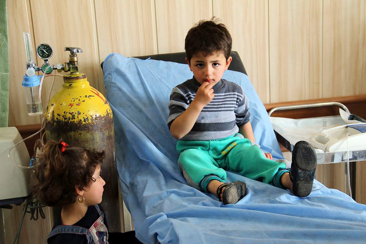 Mohammed Hussein, 3, a victim exposed to a chemical attack waits for treatment as his sister stands next to him at a hospital in Taza, 10 miles (20 kilometers) south of Kirkuk in northern Iraq.