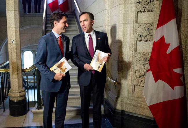 Prime Minister Justin Trudeau (left) speaks with Minister of Finance Bill Morneau as he arrives to table the budget on Parliament Hill, Tuesday, March 22, 2016, in Ottawa.