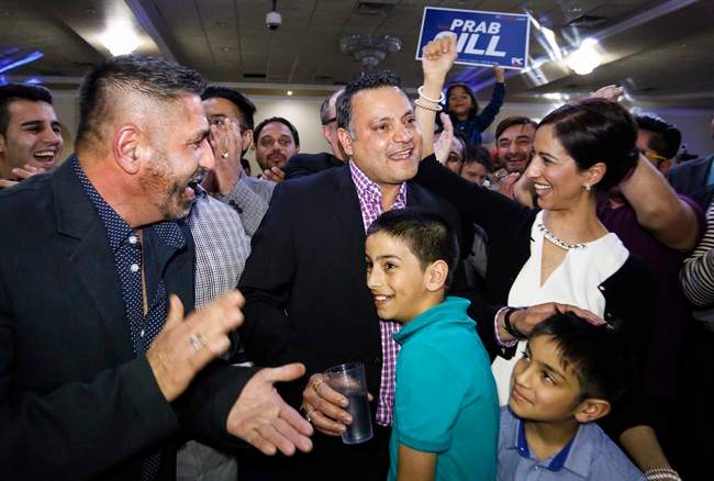Prab Gill, centre left, celebrates his byelection win in the Calgary Greenway riding in Calgary on Tuesday, March 22, 2016.