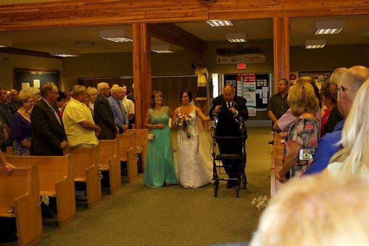 John Boden walks one of his daughters down the aisle.