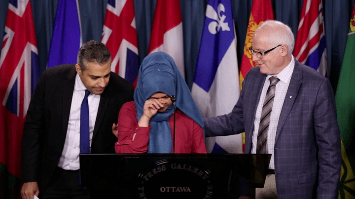 Kamila Telendibaeva speaks in support of her husband’s release with journalist Mohamed Fahmy and Secretary General of Amnesty International Canada Alex Neve during an announcement for the Protection Charter in Ottawa on on Jan. 26, 2016.