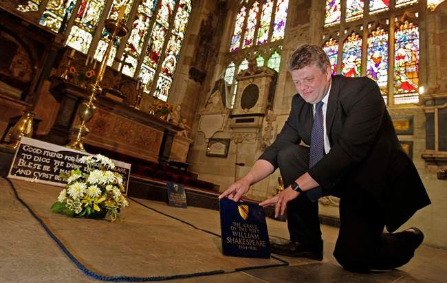 In this Monday, Sept. 21, 2009 file photo, Head Verger Jon Ormrod tends to the grave of William Shakespeare in the Chancel of Holy Trinity Church in Stratford Upon Avon, England. Archeologists who scanned the grave of William Shakespeare say they have made a startling discovery: His skull appears to be missing.