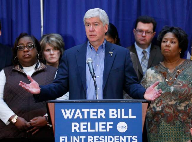In this Feb. 26, 2016 photo, Gov. Rick Snyder speaks after attending a Flint Water Interagency Coordinating Committee meeting in Flint, Mich. The state of Michigan restricted Flint from switching water sources last April unless it got approval from Gov. Rick Snyder's administration under the terms of a $7 million loan needed to help transition the city from state management, according to a document released Wednesday, March 2, 2016.