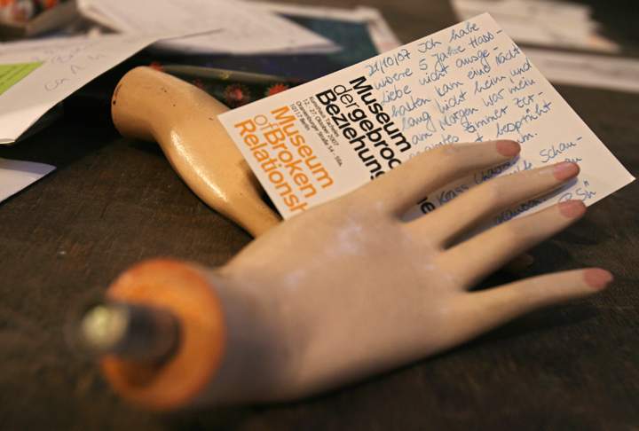 A postcard of the "Museum of Broken Relationships" held by the hands of a dummy lies on the desk for new donations 24 October 2007 at the Tacheles exhibition center in Berlin.