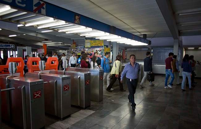 Passengers enter the Tasquena metro station in Mexico City, Wednesday, March 16, 2016. Authorities have banned more than 1 million cars from the roads and offered free subway and bus rides to coax people from their vehicles as Mexico City's first air pollution alert in 11 years stretched into a third day.
