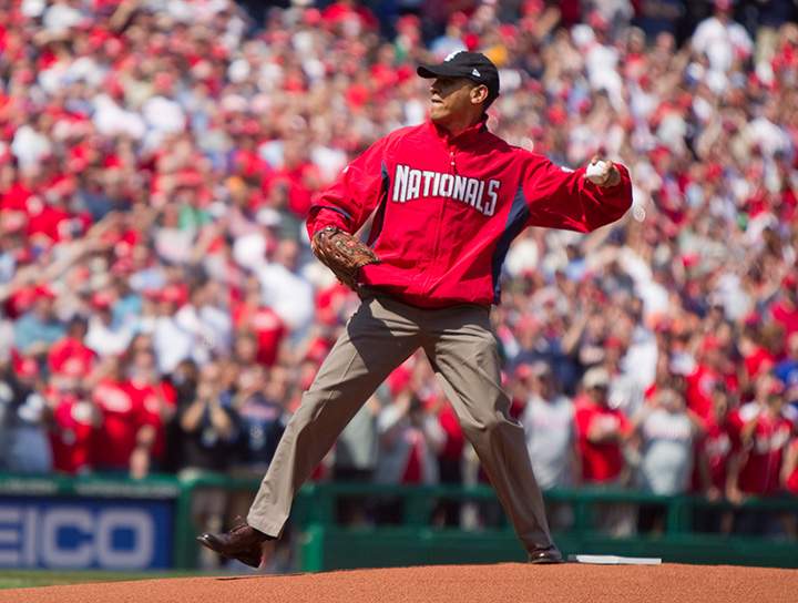 In this April 5, 2010 file photo, President Barack Obama, wearing a Washington Nationals jacket and a Chicago White Sox hat, delivers a ceremonial pitch before the Washington Nationals home opening baseball game against the Philadelphia Phillies at Nationals Park in Washington. 