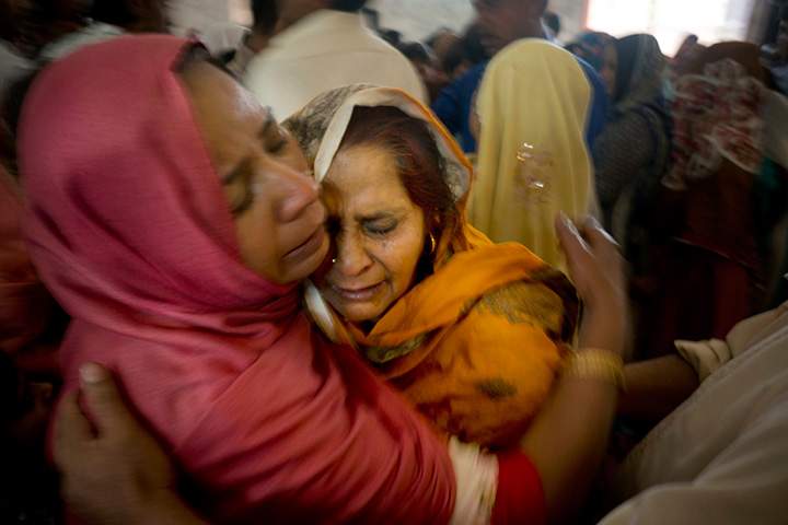 Pakistani Christian women mourn the deaths of their family members during a funeral service at a local church in Lahore, Pakistan, Monday, March 28, 2016.