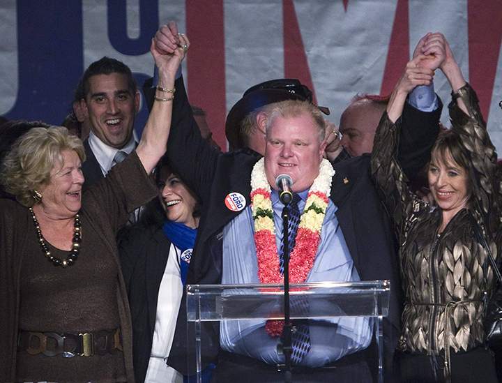 Rob Ford, centre, raises his arms with his wife Renata, right, and mother Diane, left, as he speaks to supporters in Toronto on Monday, October 25, 2010 (THE CANADIAN PRESS/Nathan Denette).