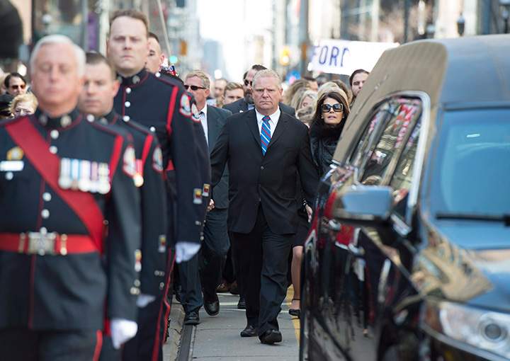 Doug Ford walks behind the hearse carrying the casket of his brother, former Toronto mayor Rob Ford, during his funeral procession to St. James Cathedral in Toronto on Wednesday, March 30, 2016.