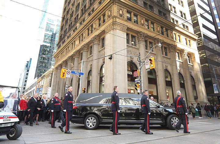 The funeral procession for former mayor Rob Ford makes its way from City Hall to St. James Cathedral in Toronto on Wednesday, March 30, 2016.