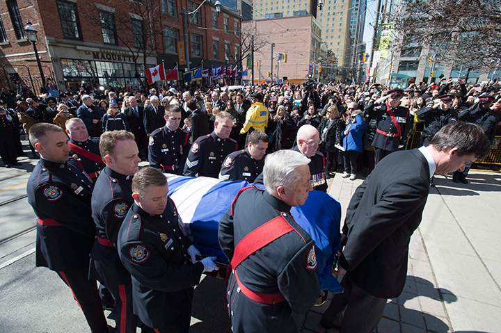 An honour guard carries the casket of former Toronto mayor Rob Ford into St. James Cathedral in Toronto on Wednesday, March 30, 2016.