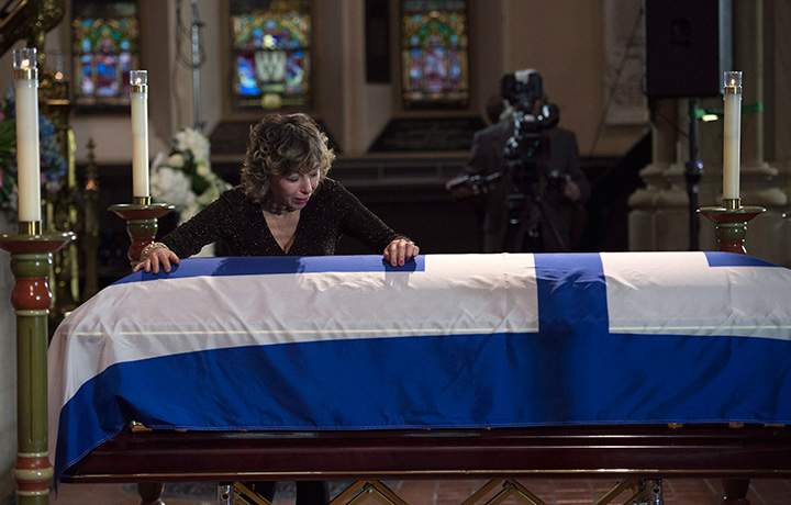 Former Toronto mayor Rob Ford’s widow Renata cries over her husband’s casket at St. James Cathedral in Toronto on Wednesday, March 30, 2016.