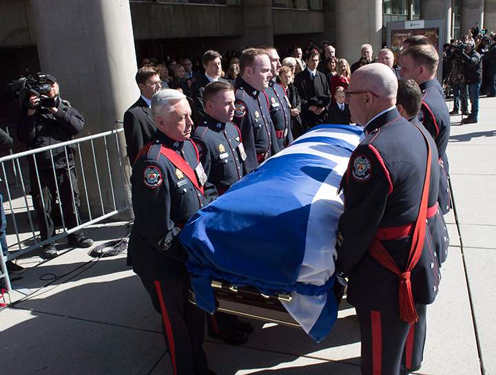 Pallbearers carry the casket of former Toronto mayor Rob Ford from city hall during his funeral procession to St. James Cathedral in Toronto on Wednesday, March 30, 2016.