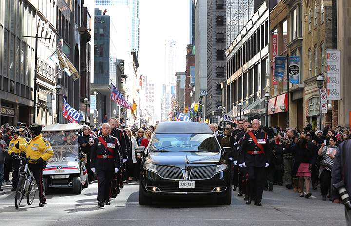 The funeral procession for former mayor Rob Ford makes its way from city hall to St. James Cathedral in Toronto on Wednesday, March 30, 2016.