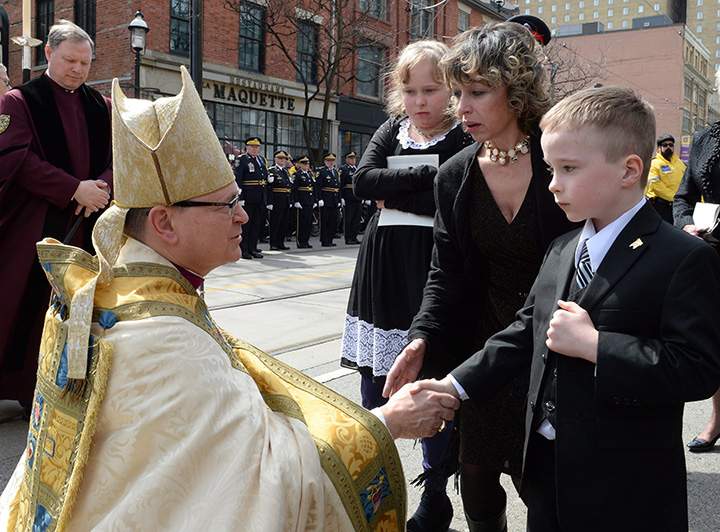 Archbishop of Toronto Colin Johnson shakes hands with former Toronto mayor Rob Ford’s son Dougie following Ford’s funeral at St. James Cathedral in Toronto on Wednesday, March 30, 2016. Ford’s widow Renata and daughter Stephanie stand behind.