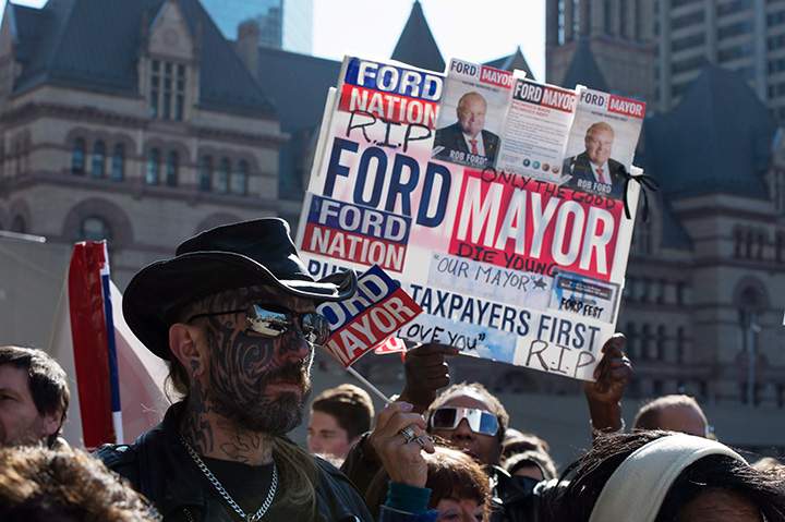 Mourners wait outside city hall ahead of the funeral procession to St. James Cathedral for former mayor Rob Ford in Toronto on Wednesday, March 30, 2016.