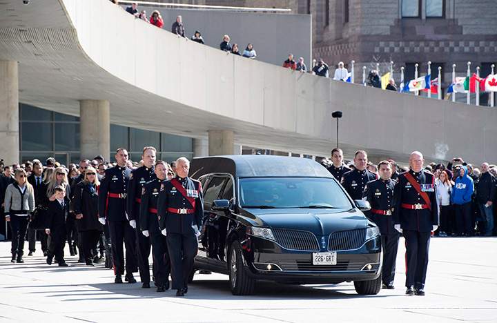 Pallbearers carry the casket of former Toronto mayor Rob Ford from city hall during his funeral procession to St. James Cathedral in Toronto on Wednesday, March 30, 2016.