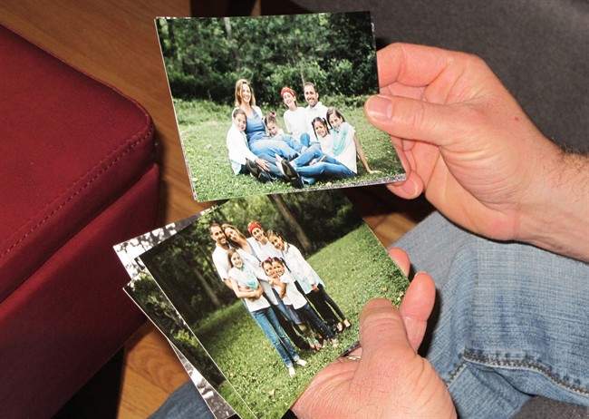In this March 11, 2016 photo, Phil Vaillancourt holds photos of his wife, Kim and their children at their home in Tonawanda, N.Y. Late last year, shortly after learning she was pregnant, Kim was diagnosed with aggressive brain cancer, and was rushed into surgery to remove two tumors that doctors said could have soon killed her. But to give her unborn baby a chance at life, Kim is postponing the chemotherapy and radiation, considered her best defense against the cancer, until after the baby's birth.