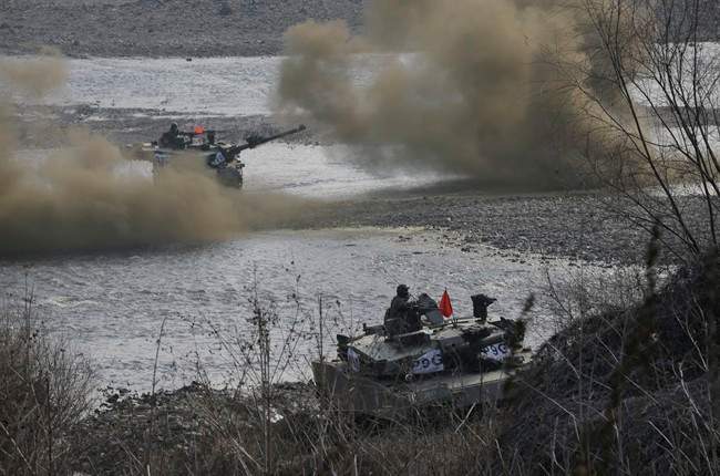 South Korean army K-1 tanks move during an annual exercise in Yeoncheon, near the border with North Korea, Thursday, March 3, 2016. North Korea fired six short-range projectiles into the sea off its east coast Thursday, Seoul officials said, just hours after the U.N. Security Council approved the toughest sanctions on Pyongyang in two decades for its recent nuclear test and long-range rocket launch. 