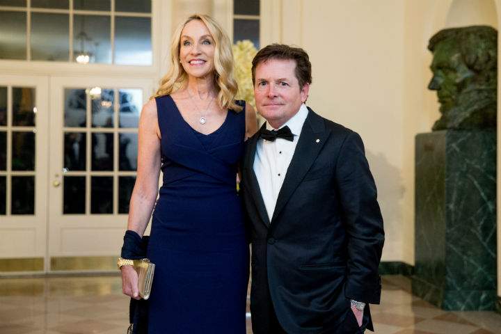 Actor Michael J. Fox and his wife Tracy Pollan pose for a photograph as they arrive for a State Dinner for Canadian Prime Minister Justin Trudeau, Thursday, March 10, 2016, at the White House in Washington.