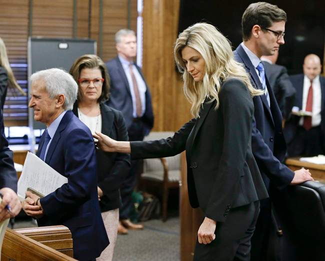 Sportscaster and television host Erin Andrews pats her attorney, Bruce Broillet, on the back after he finished his closing argument Friday, March 4, 2016, in Nashville, Tenn. Andrews has filed a $75 million lawsuit against the franchise owner and manager of a luxury hotel and a man who admitted to making secret nude recordings of her in 2008. The jury will begin deliberations Monday. 
