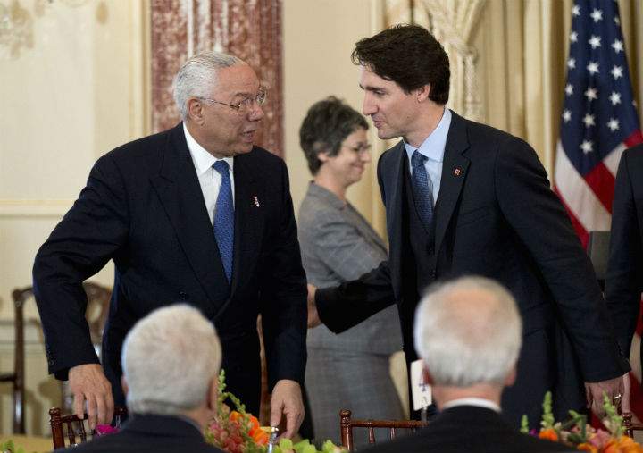 Prime Minister Justin Trudeau greets former Secretary of State Colin Powell during a luncheon meeting at the State Department in Washington, Thursday, March 10, 2016.