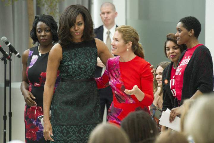 First lady Michelle Obama and Sophie Grégoire-Trudeau, wife of Canadian Prime Minister Justin Trudeau, walk to their chairs after the first lady lost her balance walking off of a stage while they participate in a program at the U.S. Institute of Peace in Washington, Thursday, March 10, 2016, to highlight Let Girls Learn efforts and raise awareness for global girl’s education.