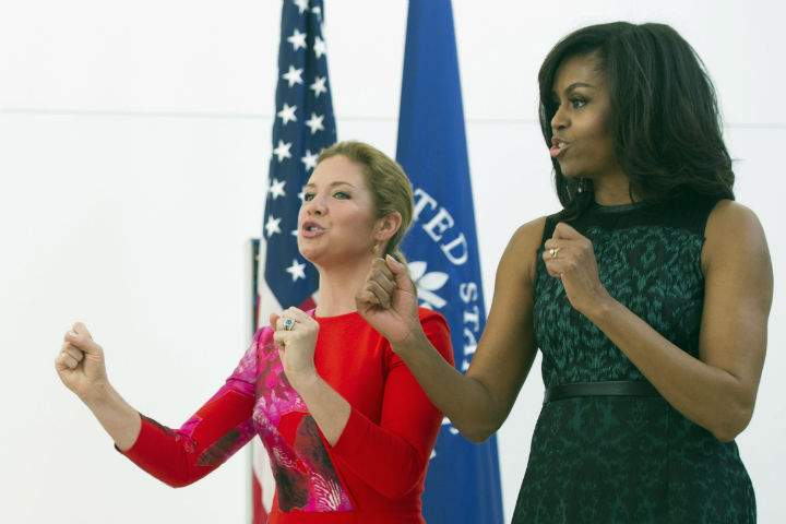 First lady Michelle Obama and Sophie Grégoire-Trudeau, wife of Canadian Prime Minister Justin Trudeau, sing along with school children during a program at the U.S. Institute of Peace in Washington, Thursday, March 10, 2016, to highlight Let Girls Learn efforts and raise awareness for global girl’s education.