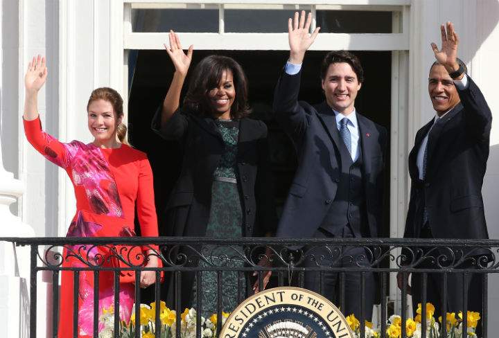 U.S. President Barack Obama (R) and Canadian Prime Minister Justin Trudeau (2nd R), U.S. first lady Michelle Obama (2nd L) and Sophie Grégoire-Trudeau wave to invited guests from the Truman Balcony of the White House after an arrival ceremony at the White House, March 10, 2016 in Washington, DC. This is Trudeau’s first trip to Washington since becoming Prime Minister.
