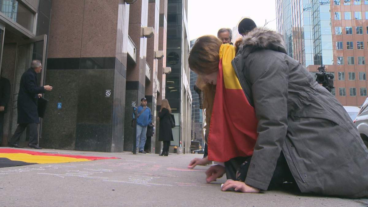 Montrealers write messages to remember victims of the Brussels attack, Wednesday, March 23, 2016.