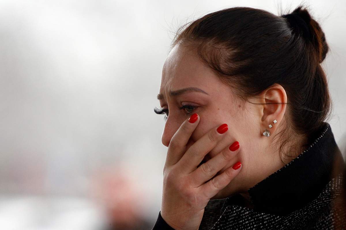 A woman mourns at the airport entrance in Rostov-on-Don on March 19, 2016, after a Boeing passenger jet operated by the flydubai budget airline crashed earlier in the day, killing all 62 people on board as it tried to land in bad weather.