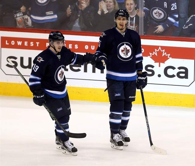 Jets forward Nic Petan (left) is now a Maple Leaf.