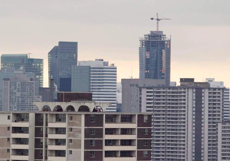 A construction crane sits atop a highrise building in Toronto in this file image. 