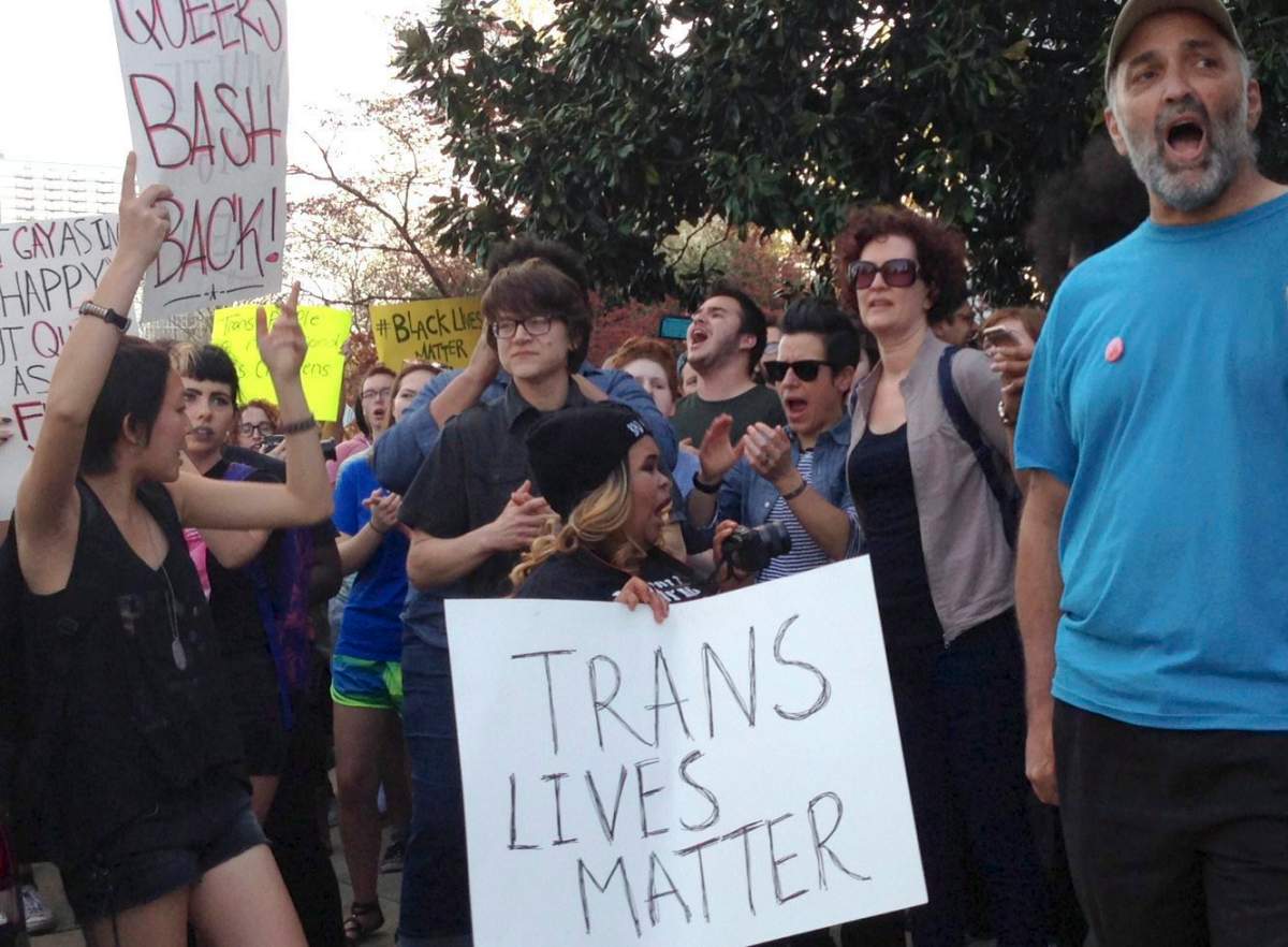 People protest outside the North Carolina Executive Mansion in Raleigh, N.C., Thursday, March 24, 2016. North Carolina legislators decided to rein in local governments by approving a bill Wednesday that prevents cities and counties from passing their own anti-discrimination rules. 
