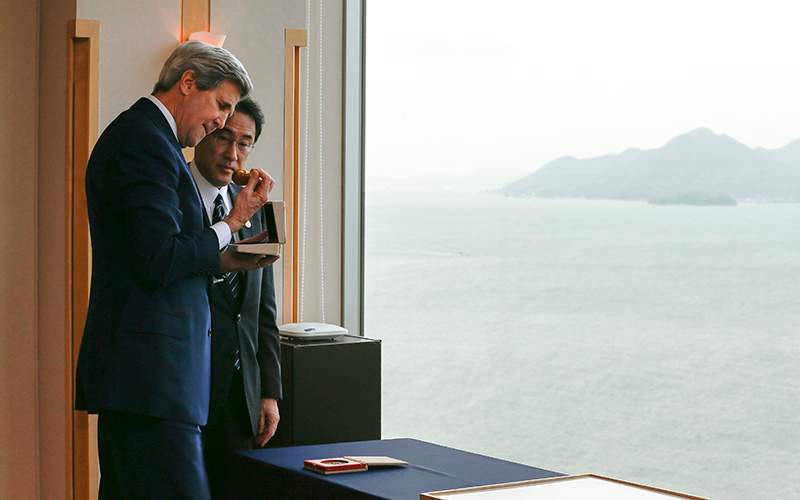 US Secretary of State John Kerry takes a look at a pocket watch as Japanese Minister for Foreign Affairs Fumio Kishida looks on during their bilateral talks prior to the second-day of the Group of Seven countries' foreign ministers meeting in Hiroshima,  Japan on April 11 2016. 