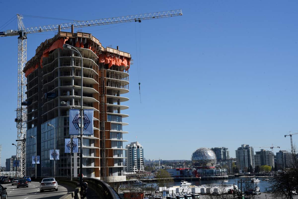 One of the three towers of the Aquilini Centre under construction next to the Georgia Viaduct on April 1, 2016 in Vancouver, British Columbia.  The tower will contain commercial space and residential rental units. BC's poorest residents spend 70% of their income on housing.