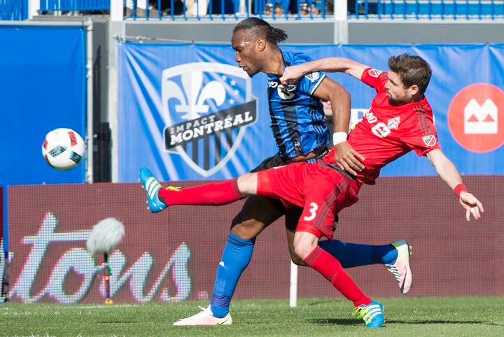 Toronto FC defender Drew Moor stretches to knock the ball away from Montreal Impact forward Didier Drogba during first half MLS action Saturday, April 23, 2016 in Montreal.