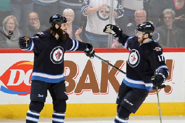 Winnipeg Jets forward Chris Thorburn celebrates his second period goal against the Minnesota Wild with teammate Adam Lowry.