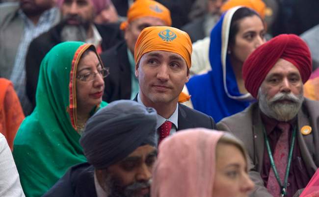 Prime Minister Justin Trudeau sits with members of the Sikh community and government caucus during a Vaisakhi Celebration on Parliament Hill in Ottawa, Monday April 11, 2016.