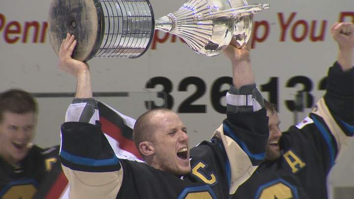 Bentley captain Don Morrison hoists the Allan Cup trophy.