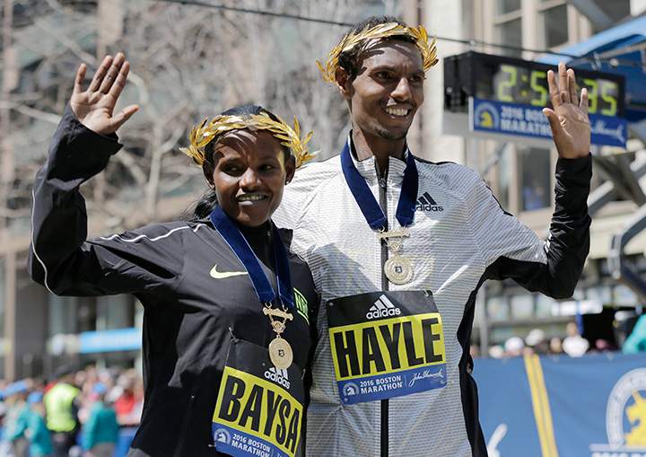 Atsede Baysa, left, and Lemi Berhanu Hayle, both of Ethiopia, pose for photos after they won the women’s and men’s divisions of the 120th Boston Marathon on Monday, April 18, 2016, in Boston.