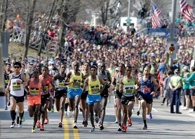 Defending champion Lelisa Desisa, of Ethiopia, center, runs at the head of the pack in the 120th Boston Marathon on Monday, April 18, 2016, in Hopkinton, Mass.