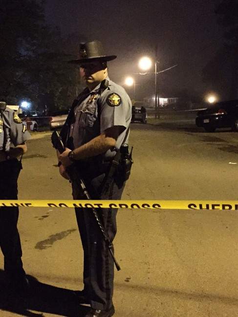 In this photo provided by courtesy of WRDW/WAGT Augusta, Columbia County Sheriff deputies investigate the scene of a shooting on Friday night, April 22, 2016, in Appling, Ga. Officials say multiple people have been killed in two shootings in northeastern Georgia.