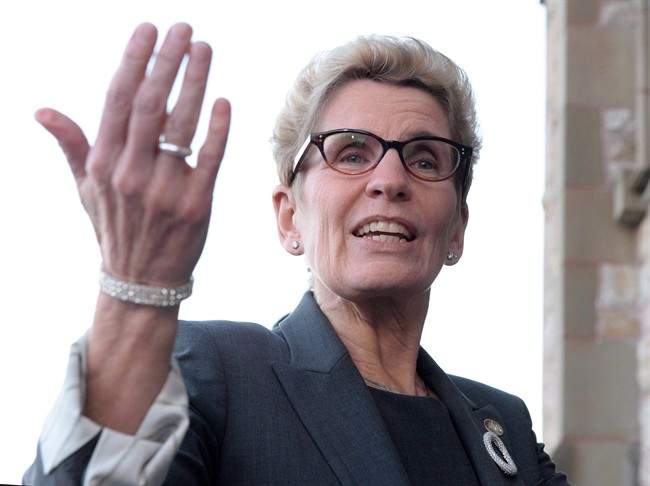 Ontario Premier Kathleen Wynne speaks to reporters in Ottawa on Monday, Nov. 23, 2015.