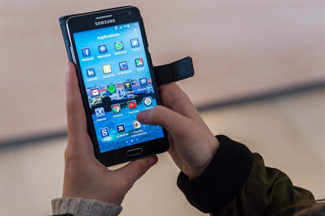 A woman uses an Android smartphone .