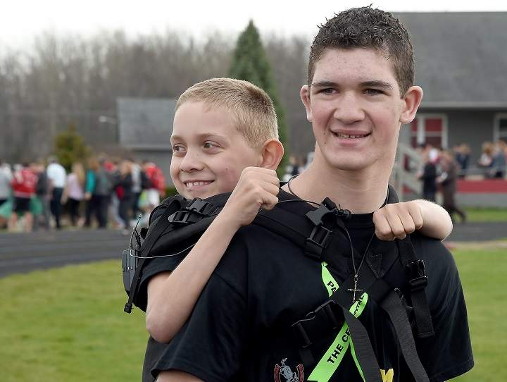 Michigan brothers Hunter Gandee, 16, and his brother Braden, 9, start their third Cerebral Palsy Swagger walk at Bedford Community Stadium Wednesday.