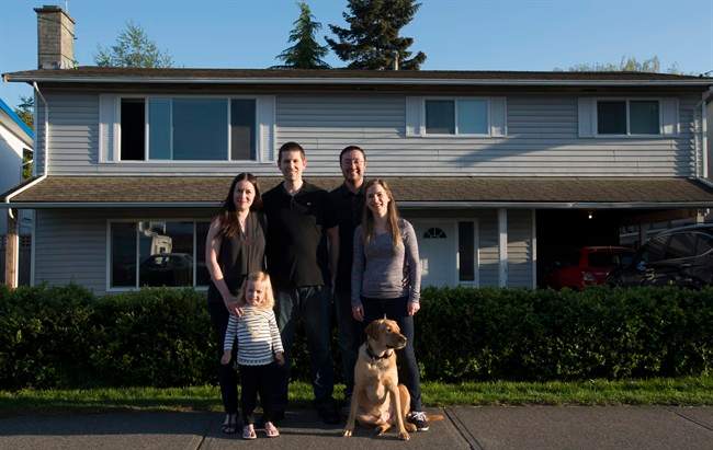 Jeremy Campbell along with his fiancee Holly Foran and dog Jake, right, shown in Delta, B.C., Monday, April, 25, 2016, bought a house together with Ryan and Christina Ingham and their two-year-old Regan. 